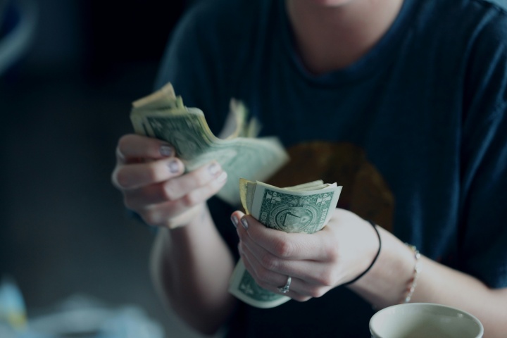 A man holding a handful of cash.