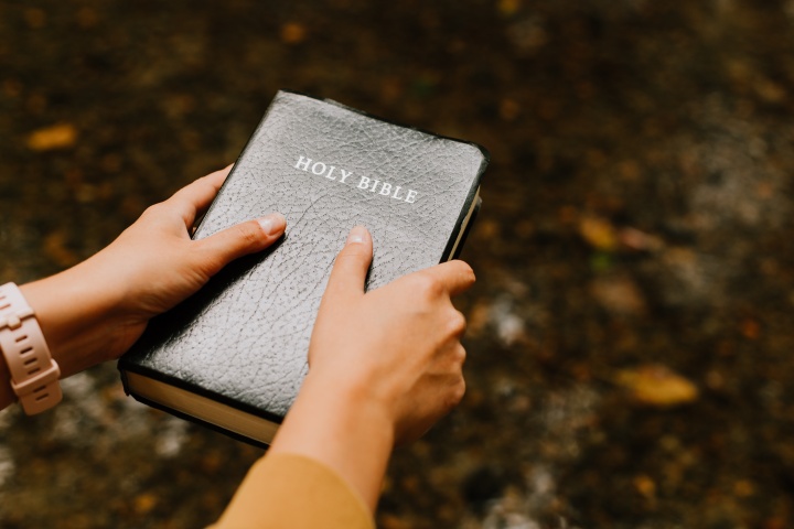 A person holding a Bible.