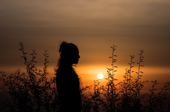 A silhouette of a young woman.