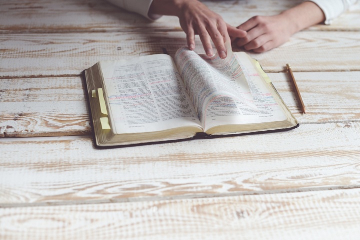 A person reading a Bible.