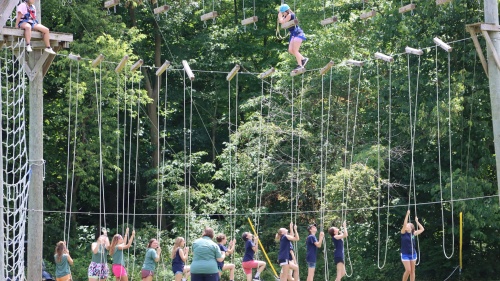 campers using a high ropes course outside