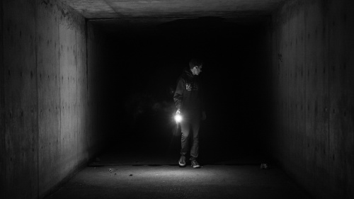 A person in a dark tunnel