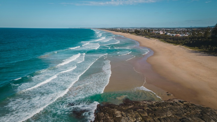 ocean coastline with a city off to the right