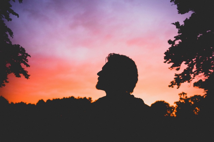 A silhouette of a man looking up.